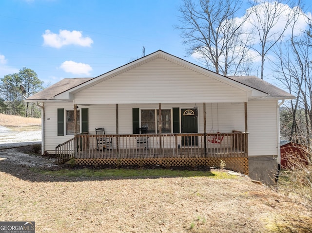 view of front of property featuring a porch and roof with shingles