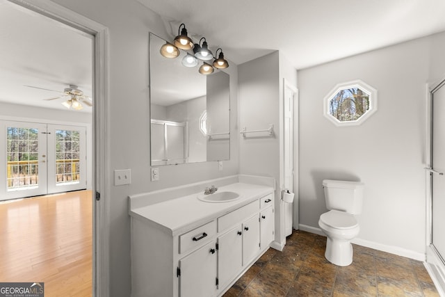 full bathroom with plenty of natural light, vanity, baseboards, and a shower with shower door