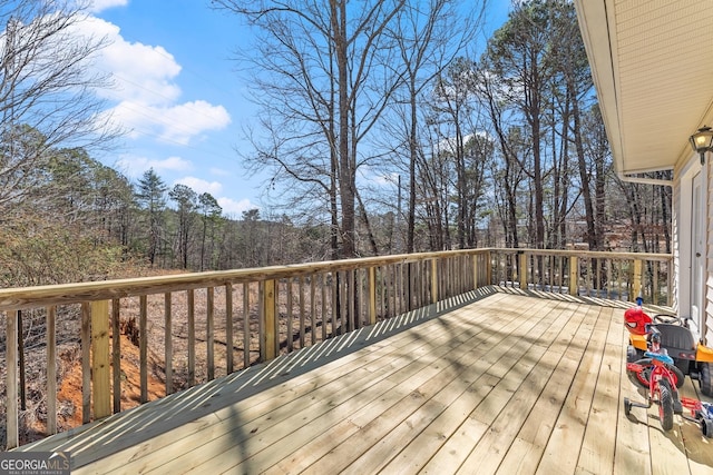 wooden terrace with a wooded view