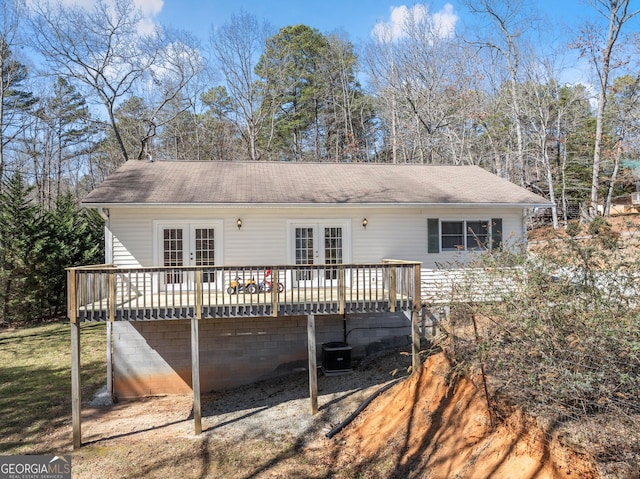 rear view of house with french doors and a wooden deck