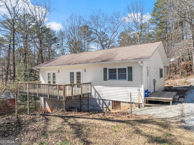 back of house featuring french doors and a wooden deck