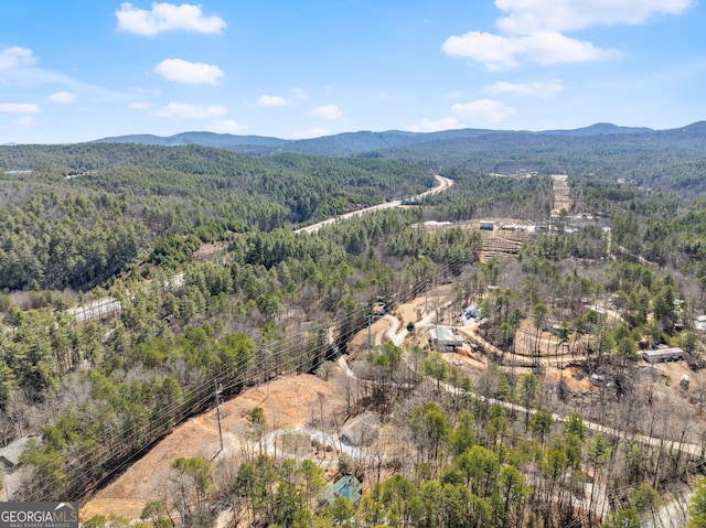 birds eye view of property featuring a mountain view and a view of trees