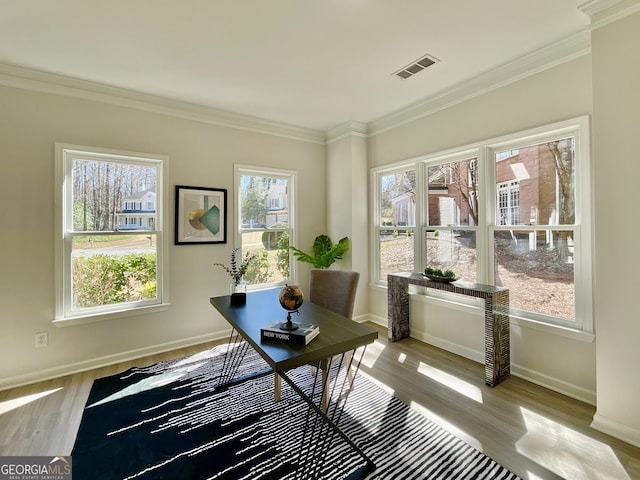 office space with light wood-type flooring, visible vents, and plenty of natural light