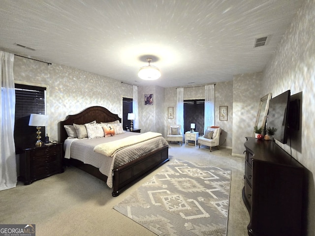 carpeted bedroom featuring visible vents and wallpapered walls