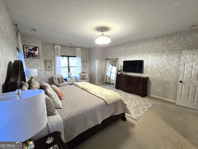 bedroom featuring light carpet, baseboards, visible vents, and wallpapered walls