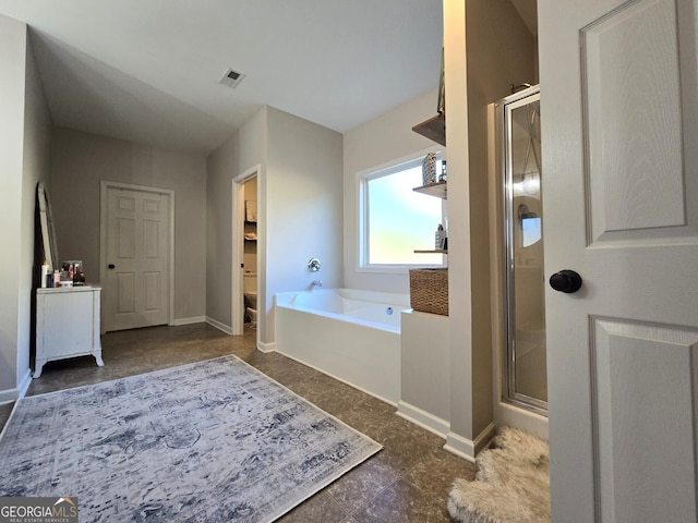 bathroom with a garden tub, a shower stall, visible vents, and baseboards