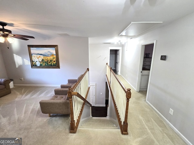 staircase with carpet, visible vents, attic access, ceiling fan, and baseboards