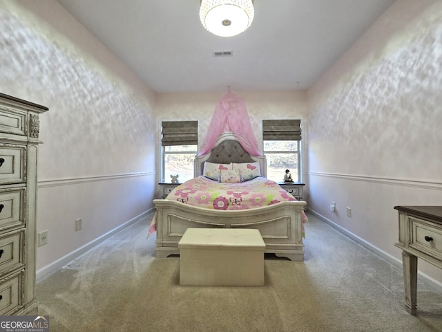 bedroom with carpet floors, baseboards, and visible vents