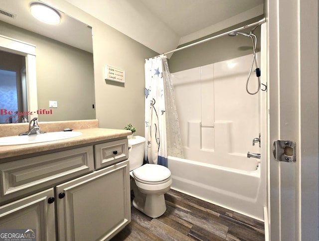 full bath with visible vents, toilet, wood finished floors, shower / bathtub combination with curtain, and vanity