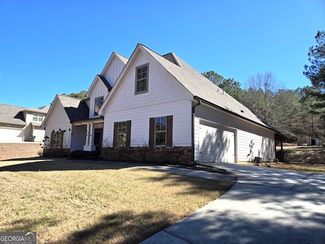 view of front of home featuring a shingled roof, board and batten siding, a garage, driveway, and a front lawn