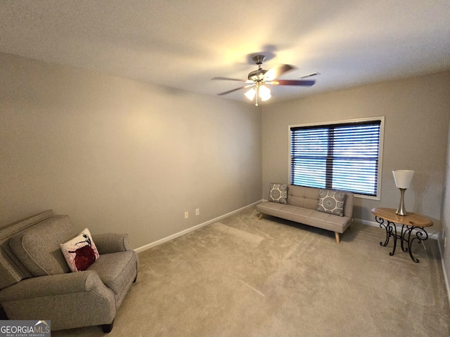 sitting room with baseboards, visible vents, ceiling fan, and carpet flooring