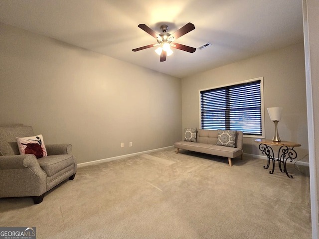 living area featuring a ceiling fan, carpet, visible vents, and baseboards