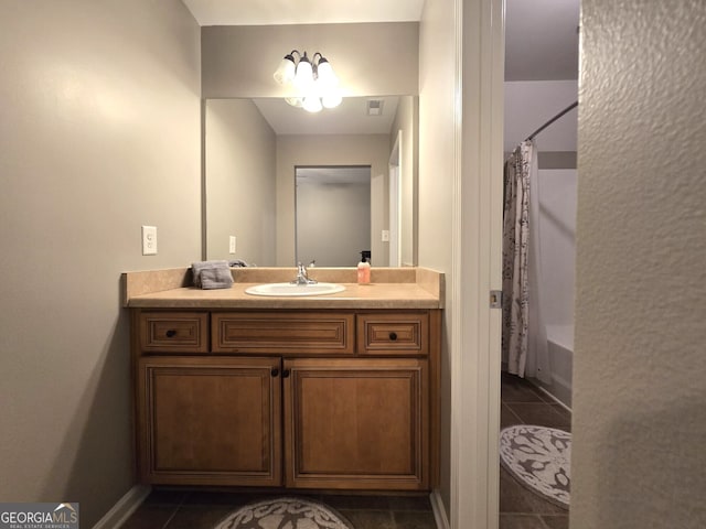 full bath featuring vanity, visible vents, shower / bath combo with shower curtain, and tile patterned floors