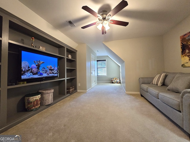 carpeted living room with built in shelves, visible vents, ceiling fan, and baseboards