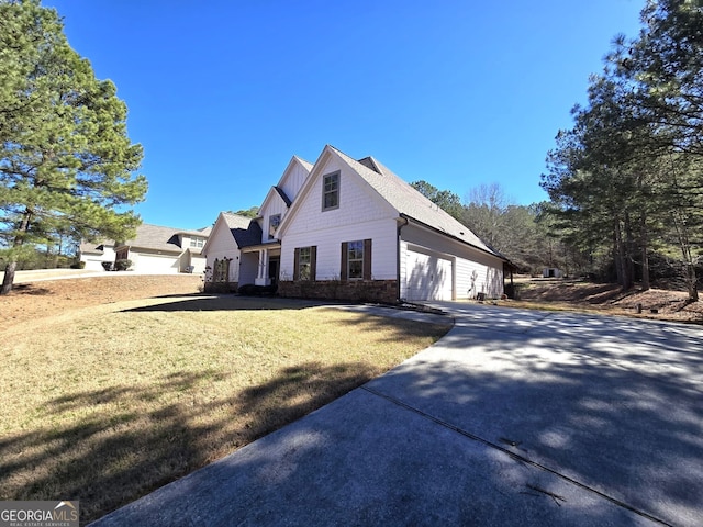 view of front of property featuring concrete driveway, brick siding, an attached garage, and a front lawn