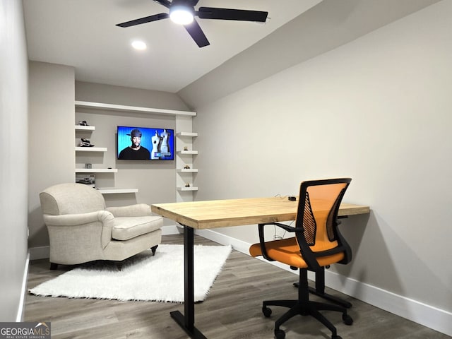 office area with a ceiling fan, vaulted ceiling, baseboards, and wood finished floors