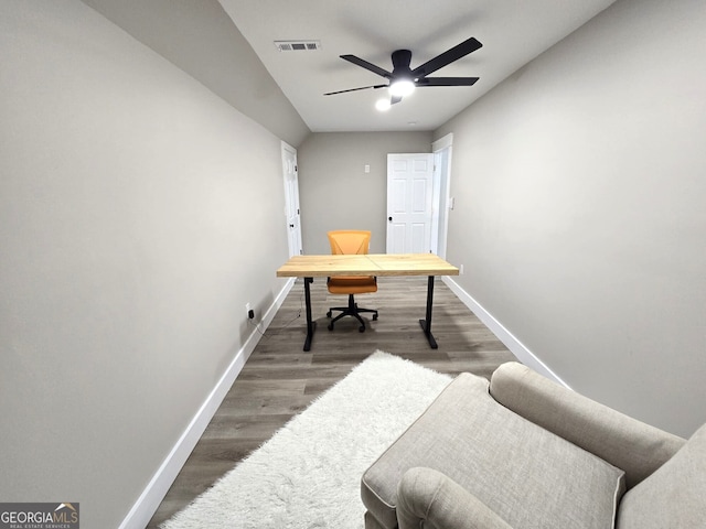 home office featuring a ceiling fan, visible vents, baseboards, and wood finished floors