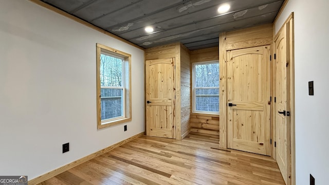 interior space featuring light wood finished floors and baseboards