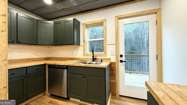 kitchen featuring light wood-type flooring, a sink, wood counters, and stainless steel dishwasher