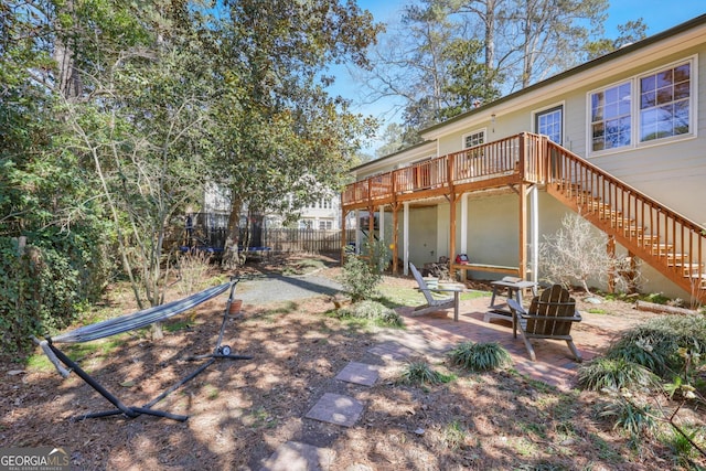 2484 Oldfield Rd NW, Atlanta, GA 30327 - view of yard featuring a deck, a patio, fence, stairway, and a trampoline