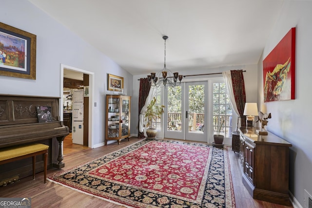 2484 Oldfield Rd NW, Atlanta, GA 30327 - dining area with lofted ceiling, baseboards, an inviting chandelier, and wood finished floors