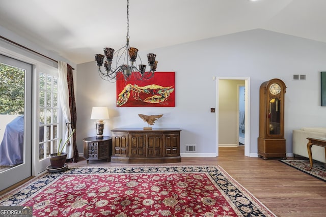 2484 Oldfield Rd NW, Atlanta, GA 30327 - living area featuring a notable chandelier, visible vents, vaulted ceiling, and wood finished floors