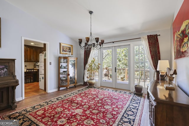 2484 Oldfield Rd NW, Atlanta, GA 30327 - interior space featuring a chandelier, lofted ceiling, baseboards, and wood finished floors