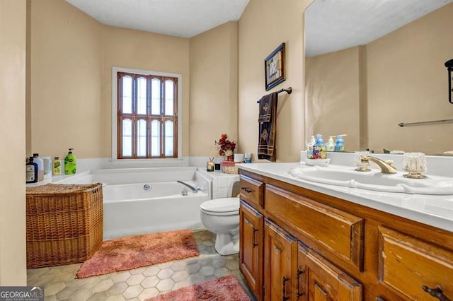 full bathroom with tile patterned floors, vanity, toilet, and a bath