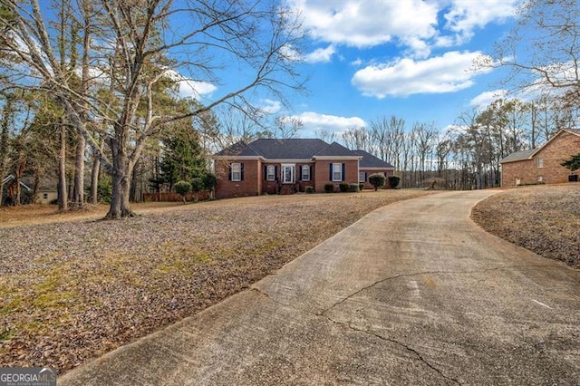 ranch-style house featuring concrete driveway