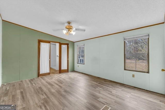 unfurnished bedroom featuring light wood finished floors and ornamental molding