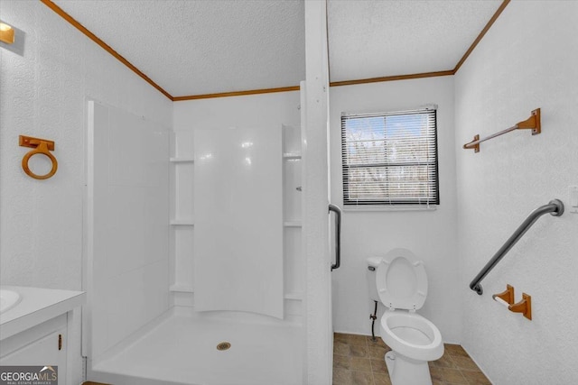 bathroom with ornamental molding, a stall shower, a textured ceiling, and vanity