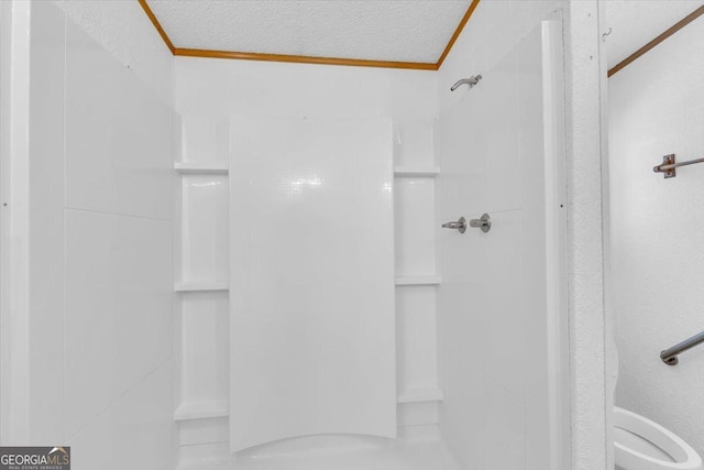 full bath featuring ornamental molding, walk in shower, and a textured ceiling