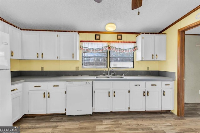 kitchen featuring light wood-style floors, white cabinets, a sink, a textured ceiling, and white appliances