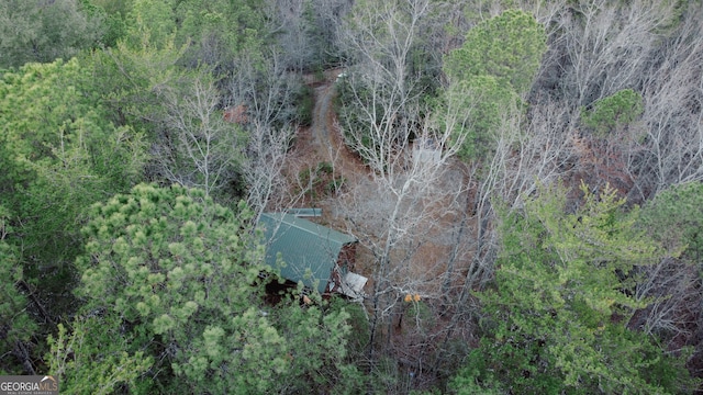 drone / aerial view featuring a wooded view