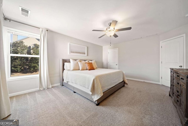 bedroom with light carpet, visible vents, and baseboards