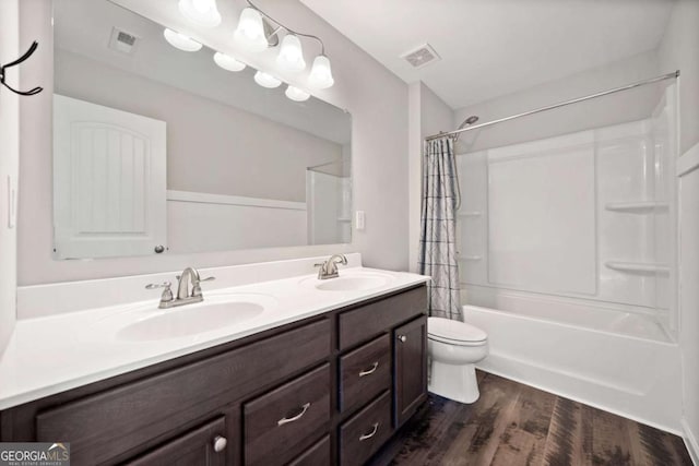 full bath featuring wood finished floors, a sink, and visible vents