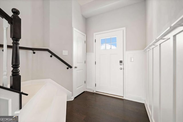 foyer entrance featuring stairway and dark wood finished floors