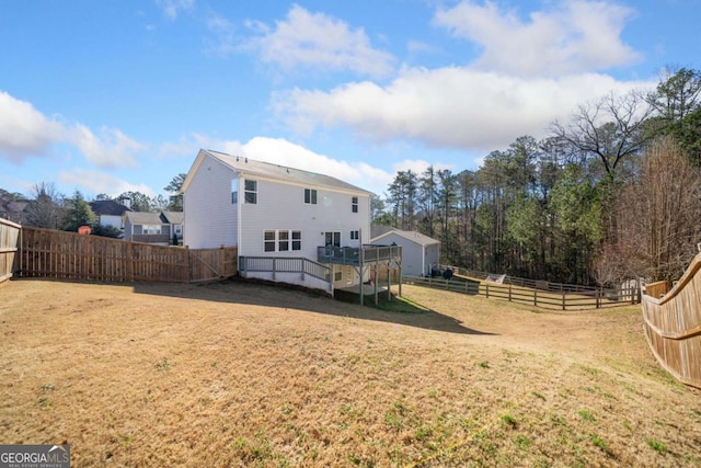 back of house featuring a fenced backyard, a yard, and a deck