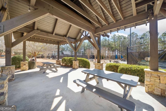 view of patio / terrace with outdoor dining space, fence, and a gazebo