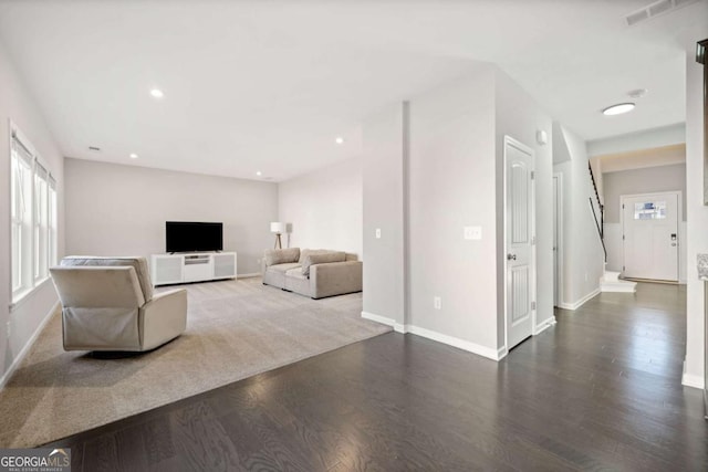 unfurnished living room featuring recessed lighting, visible vents, baseboards, and wood finished floors