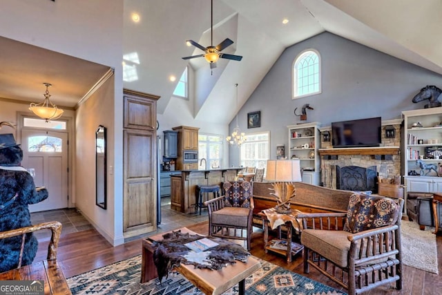 537 Mill Ridge Rd, Hiawassee, GA 30546 - living room with ceiling fan with notable chandelier, high vaulted ceiling, a stone fireplace, and wood finished floors