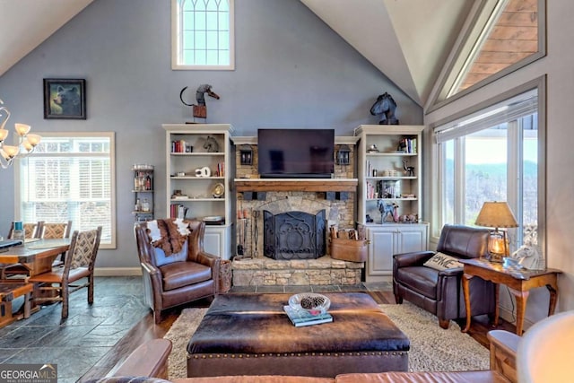 537 Mill Ridge Rd, Hiawassee, GA 30546 - living area featuring lofted ceiling, a fireplace, baseboards, and a notable chandelier