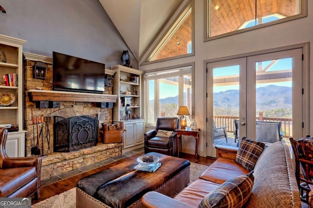 537 Mill Ridge Rd, Hiawassee, GA 30546 - living room featuring a fireplace, high vaulted ceiling, wood finished floors, and french doors
