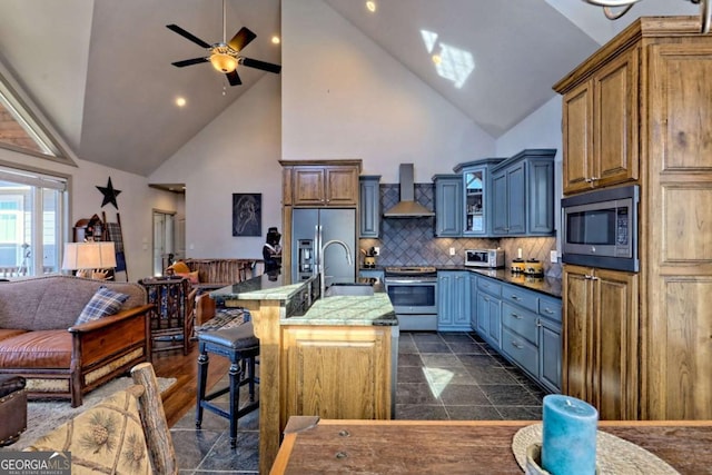 537 Mill Ridge Rd, Hiawassee, GA 30546 - kitchen featuring stainless steel appliances, open floor plan, a sink, wall chimney range hood, and a kitchen breakfast bar