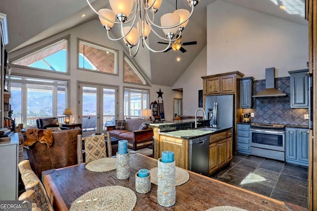 537 Mill Ridge Rd, Hiawassee, GA 30546 - kitchen with stainless steel appliances, dark countertops, open floor plan, a sink, and wall chimney exhaust hood