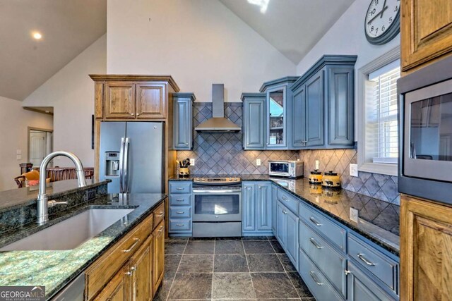 537 Mill Ridge Rd, Hiawassee, GA 30546 - kitchen with a sink, wall chimney range hood, appliances with stainless steel finishes, brown cabinets, and dark stone countertops