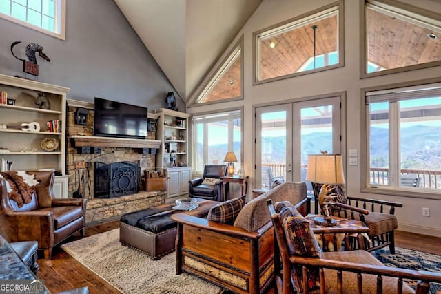 537 Mill Ridge Rd, Hiawassee, GA 30546 - living room with french doors, plenty of natural light, a stone fireplace, and wood finished floors