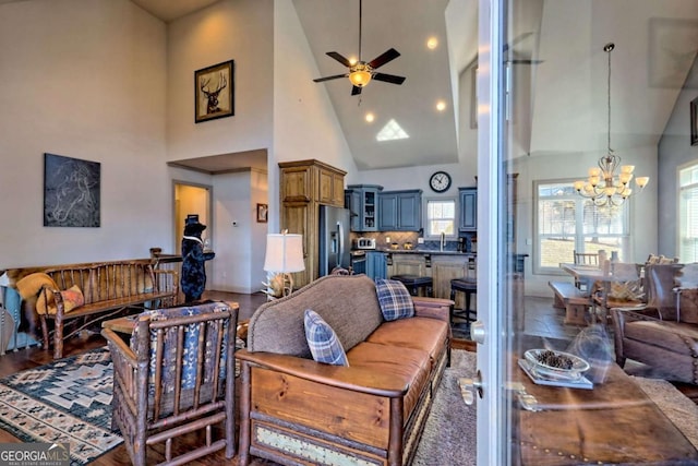 537 Mill Ridge Rd, Hiawassee, GA 30546 - living area with ceiling fan with notable chandelier, high vaulted ceiling, and dark wood-style flooring