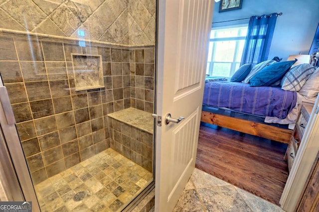 537 Mill Ridge Rd, Hiawassee, GA 30546 - bathroom featuring a stall shower, connected bathroom, and wood finished floors