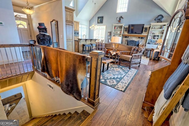 537 Mill Ridge Rd, Hiawassee, GA 30546 - living room with high vaulted ceiling, wood-type flooring, a healthy amount of sunlight, and a stone fireplace